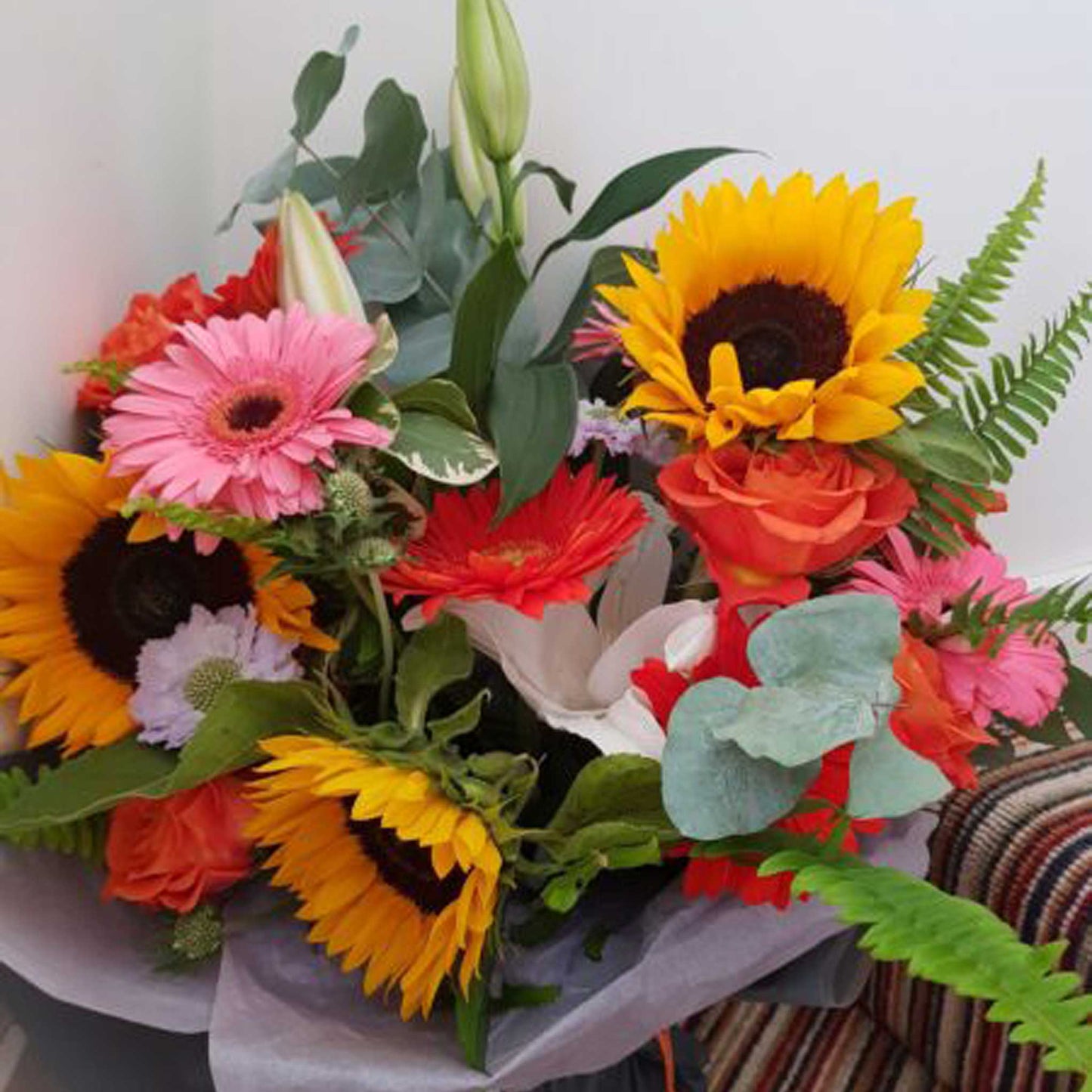 Florist Choice - Brights by ReCreation Flowers: a vibrant, handcrafted bouquet of sunflowers, gerberas, roses, lilies, ferns & eucalyptus—available for same-day delivery from your Leigh on Sea florist.