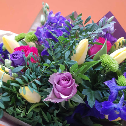 Florist Choice - Brights by ReCreation Flowers features vibrant seasonal blooms, expertly arranged by your Leigh on Sea florist and set against a bold orange background.