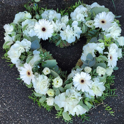 The Open Heart Funeral Flowers - Loose Style by ReCreation Flowers features white gerbera daisies, roses, hydrangeas, and greenery arranged in a stunning heart shape for a meaningful tribute.